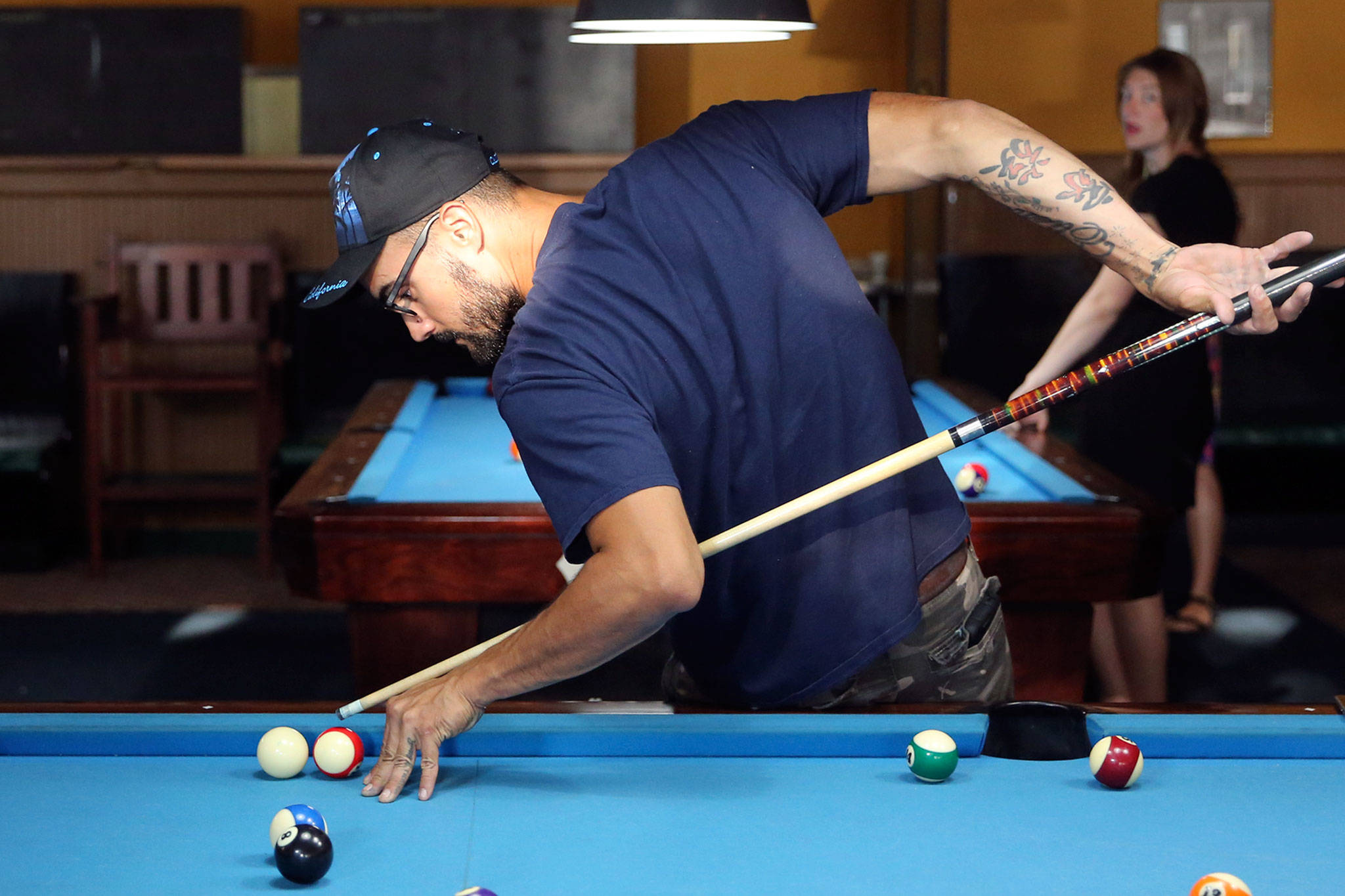 Wilker Leite lines up a shot at the Golden Fleece Billiards in Everett. (Kevin Clark / The Herald)