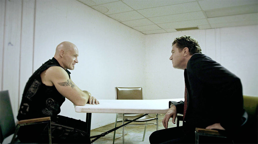Ansel Schneider (Ralf Scheepers) is interrogated by Detective Armitage (Kevin Cusick) in “Devil’s Five.” (Mantaray Pictures LLC/Cool Creative/HERMANOfilms)
