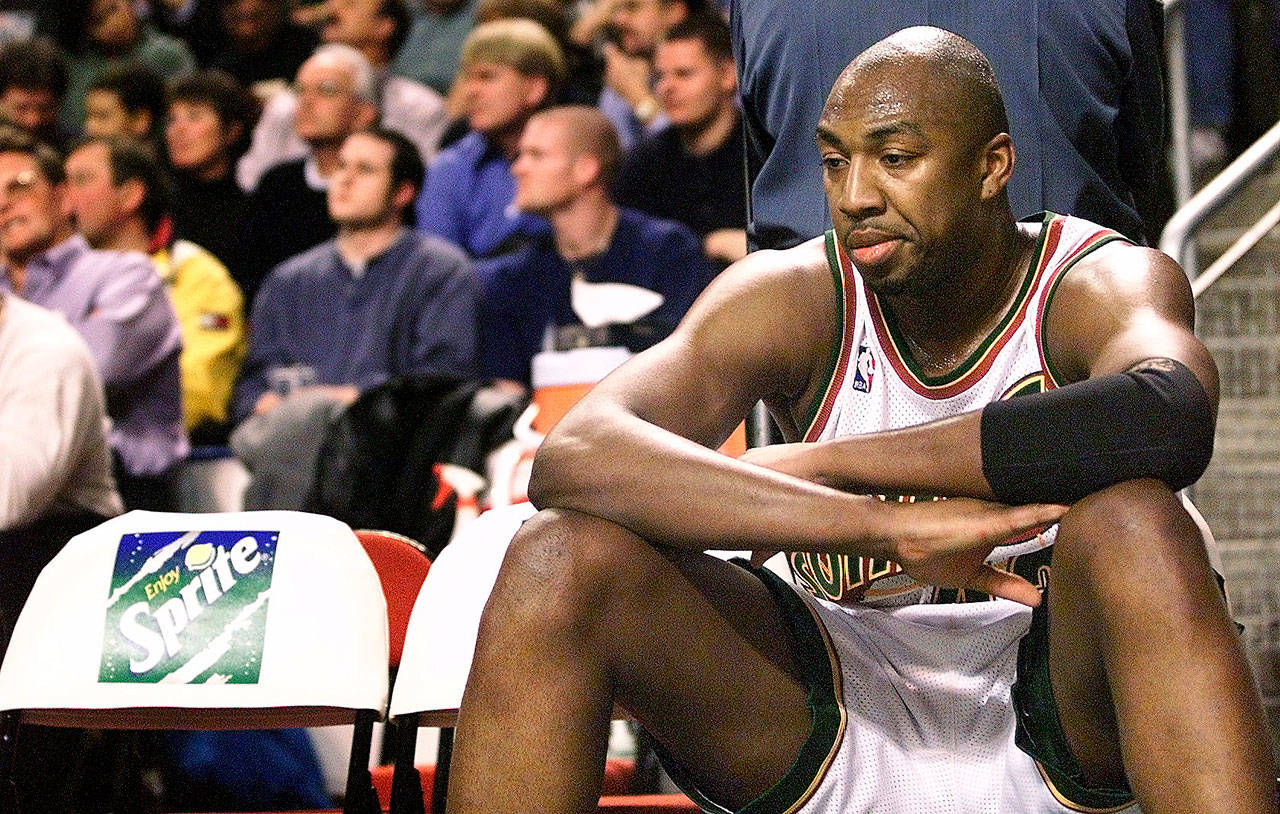 Seattle’s Vin Baker sits on the bench during a Sonics’ timeout during a loss to Phoenix on March 4, 1999 in Seattle. Baker has traveled a long road to redemption after a battle with alcoholism. (Justin Best / The Herald)