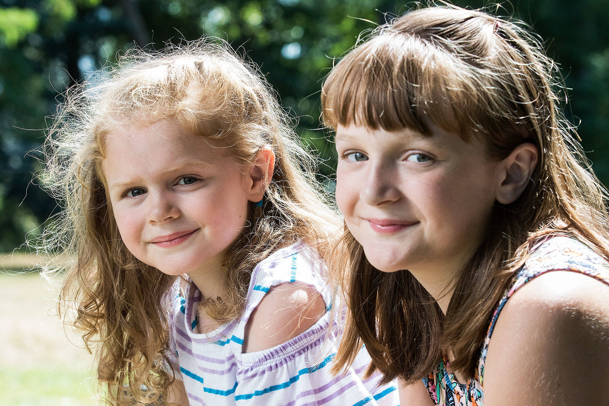 Kelly Estes’ daughters Reese, 4 (left), and Ella 10, both needed to have temporary tubes in their ears due to ongoing ear infections. A new app being developed by a University of Washington physician will help parents determine whether their kids have the infections. (Andy Bronson / The Herald)