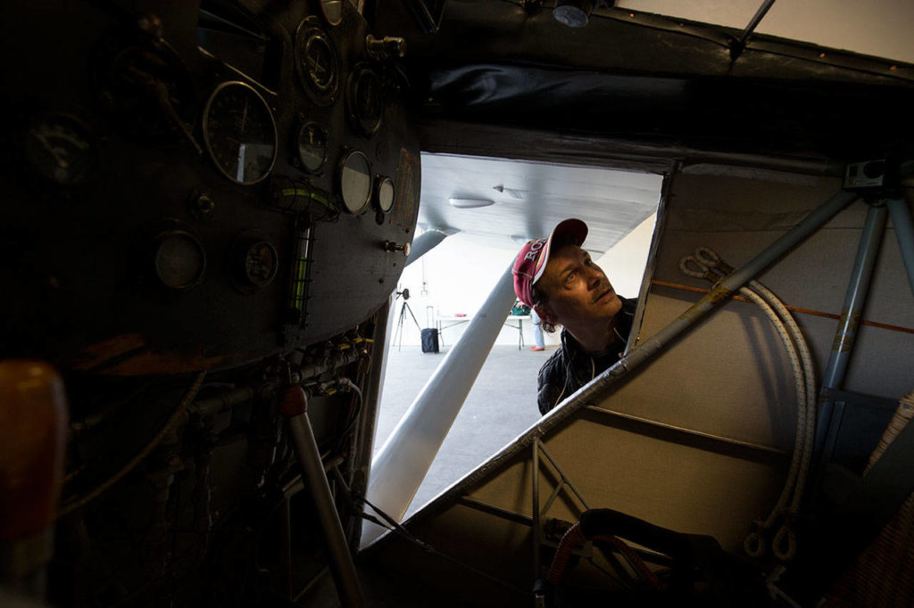 Antony Giacomini looks around the cockpit of John Norman’s replica of the Spirit of St. Louis on July 28. Giacomini is also building a replica but remarked that Norman’s was an exact replica, compared to his plane. (Andy Bronson / The Herald)
