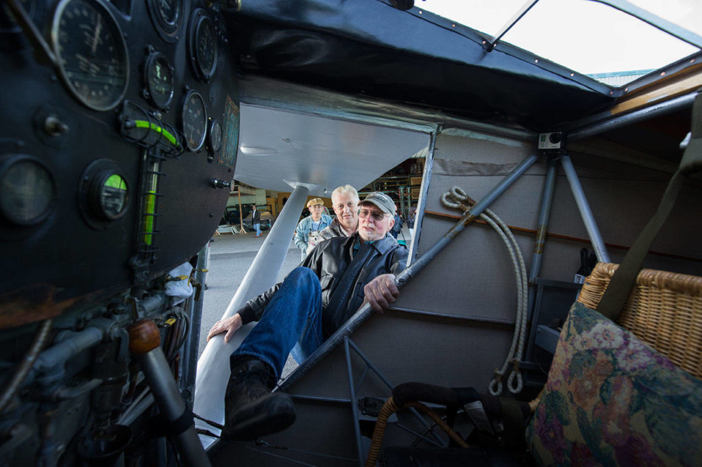 Getting into the cockpit is no easy feat as pilot Ron Fowler stretches a leg into John Norman’s replica of the Spirit of St. Louis before taking the plane out on its first flight July 28. (Andy Bronson / The Herald)
