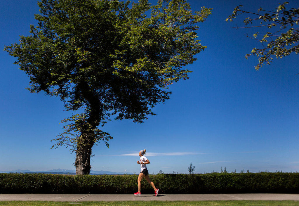 Miranda Granger runs through Grand Avenue park on July 26, 2019, in Everett. (Olivia Vanni / The Herald)
