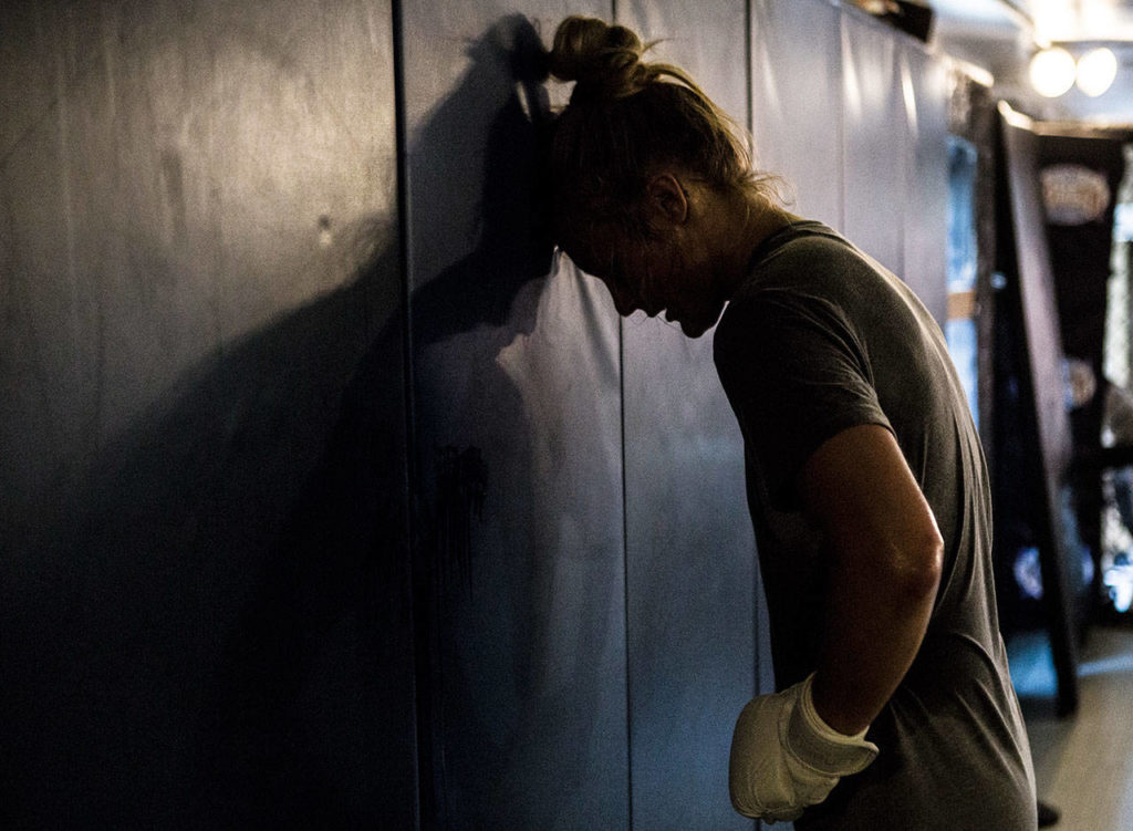 Miranda Granger rests her head against the wall during her training session at Charlie’s Combat Club on July 26, 2019, in Everett. (Olivia Vanni / The Herald)
