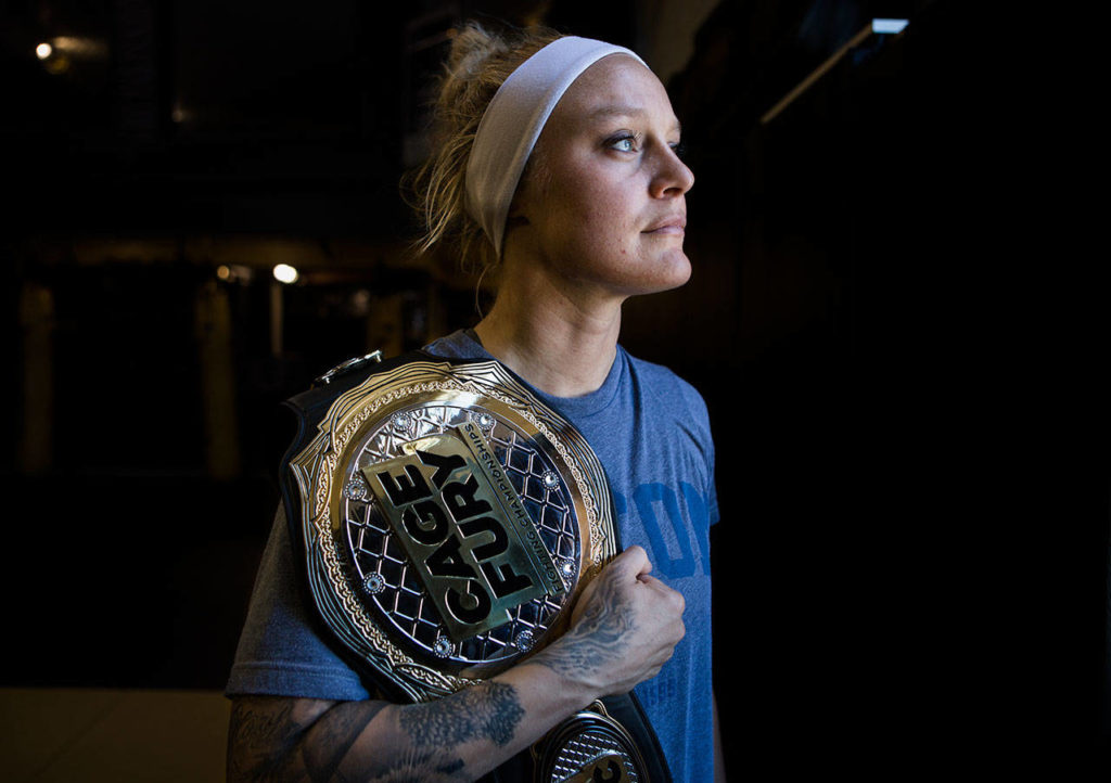 Miranda Granger with her Cage Fury belt at Charlie’s Combat Club on July 26, 2019, in Everett. (Olivia Vanni / The Herald)
