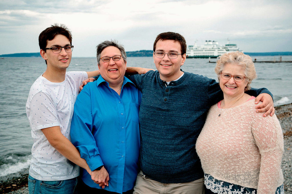 Ian Davis-Leonard (left) and his brother Sam hug their moms Amy Leonard (left) and Betsy Davis Currier. Ian Davis-Leonard has been The Herald’s news intern this summer. He’ll soon begin his senior year at Gonzaga University. (Photo courtesy Ian Davis-Leonard)
