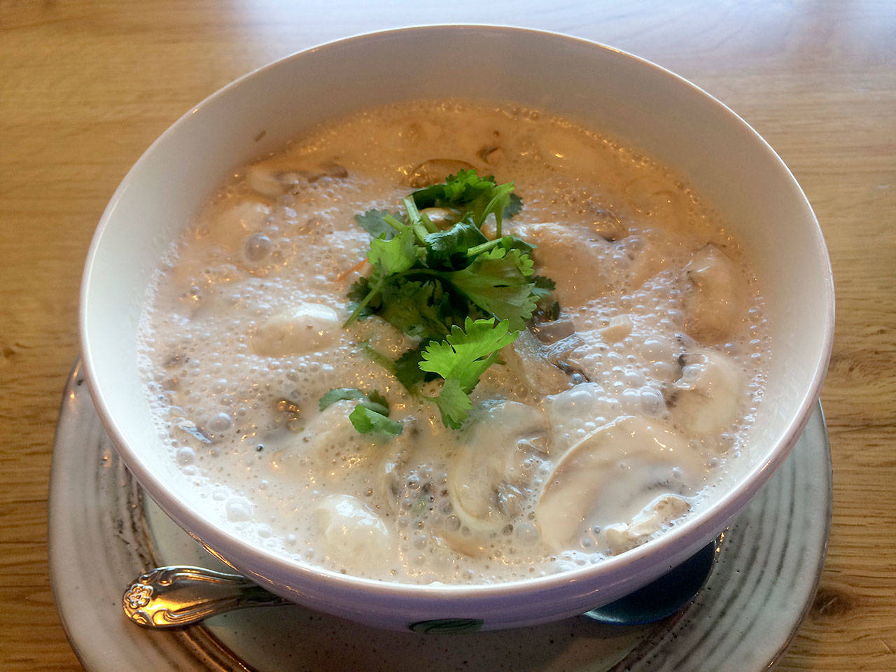 Charm Gai’s tom kah gai is a spicy, sour and slightly sweet soup with mushrooms, coconut milk, chicken, lemongrass, kaffir lime leaves and galangal. (Evan Thompson / The Herald)