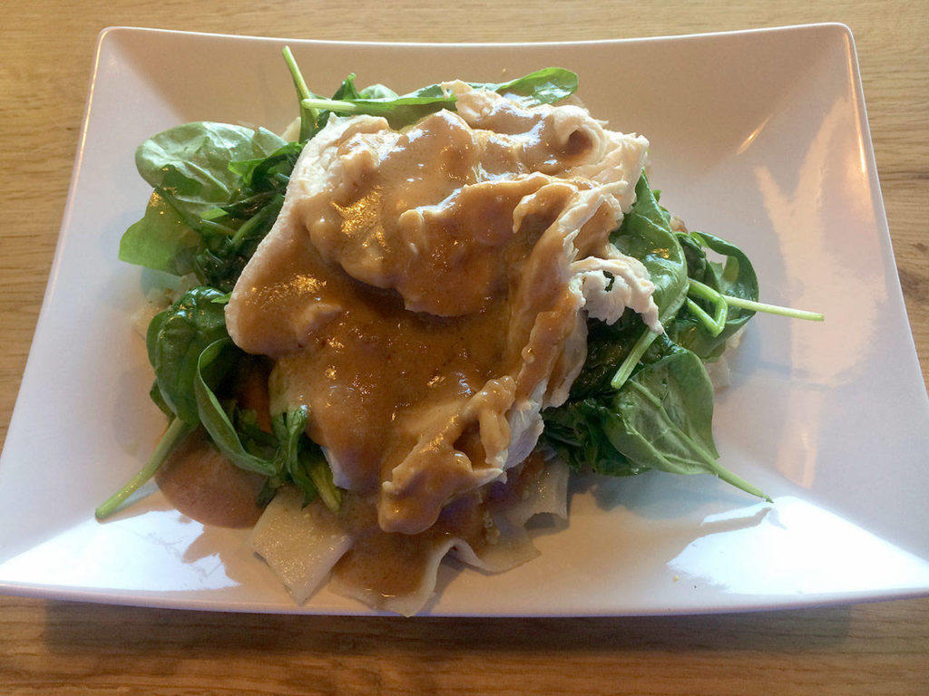 Rama noodles include sauteed rice noodles, eggs, spinach and chicken, topped with homemade peanut sauce. (Evan Thompson / The Herald)
