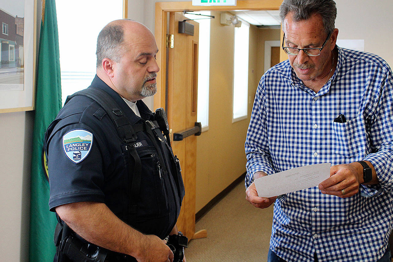 Officer Don Lauer is sworn in as acting police chief by Langley Mayor Tim Callison in July 2018. (Patricia Guthrie / Whidbey News Group, file)