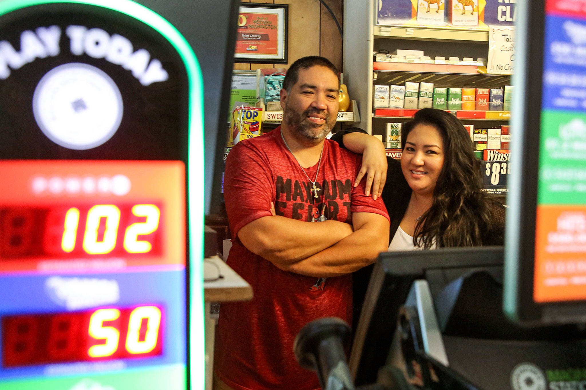 Charlie Andrade with his sister, Anna Andrade, at the family-owned Brier Grocery, which recently sold a $12.2 million Lotto ticket. The small neighborhood market received a $122,000 bonus commission from the state for selling the winning ticket. (Kevin Clark / The Herald)