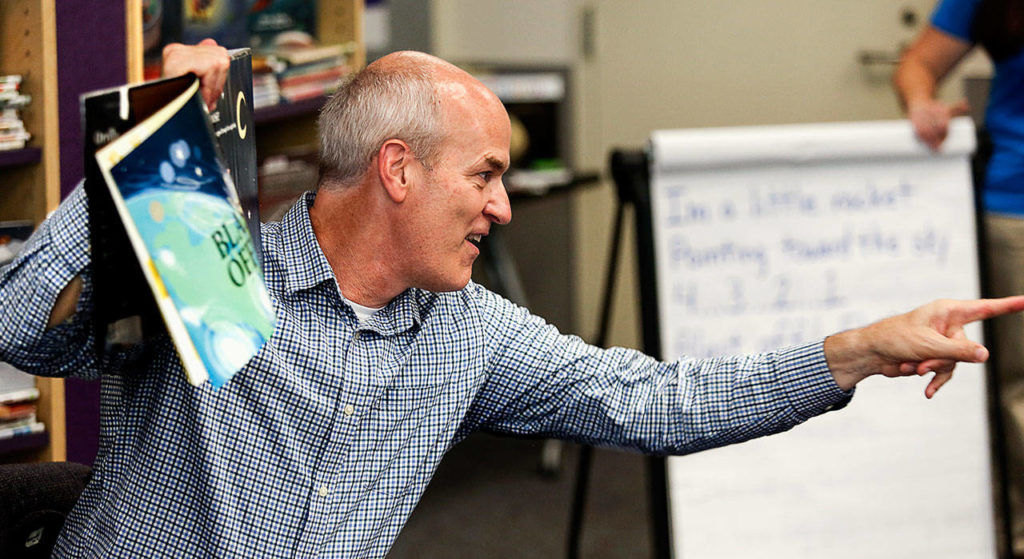 In lively fashion, Congressman Rick Larsen takes a question from one of several dozen kids listening to him read the illustrated book “Penguinaut!” on Thursday at Sno-Isle’s Marysville Library while visiting with Librarian of Congress Carla Hayden. (Dan Bates / The Herald)
