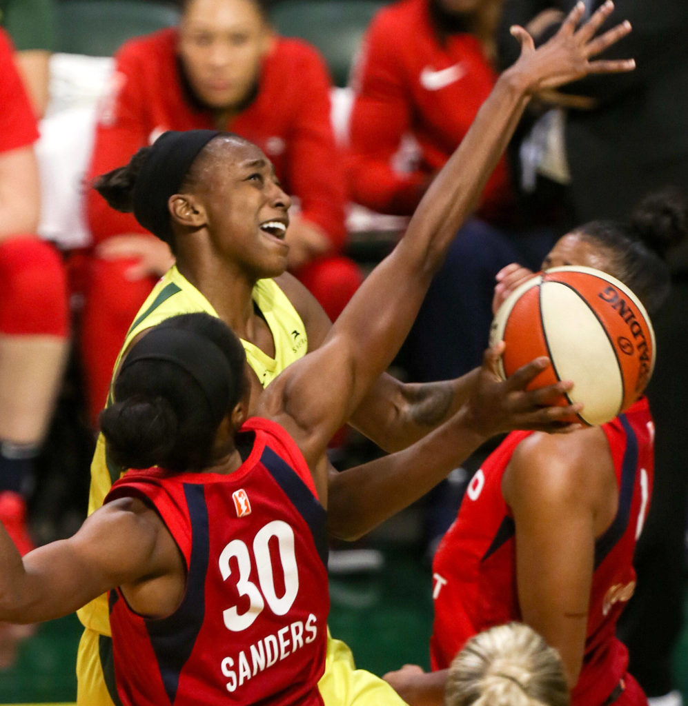 Seattle’s Jewell Loyd attempts a shot with Washington’s LaToya Sanders defending during a game on Aug. 2, 2019, at Angel of the Winds Arena in Everett. (Kevin Clark / The Herald)

