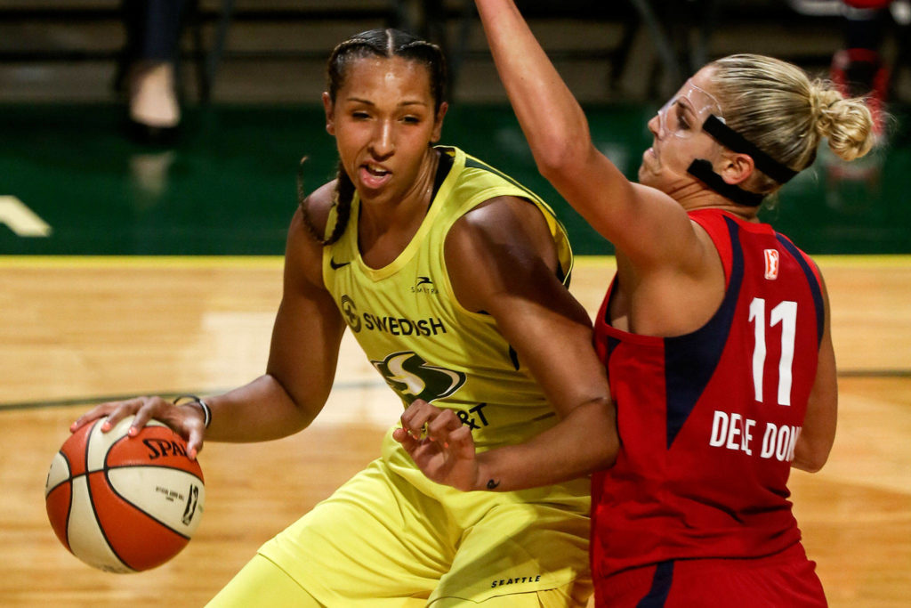 Seattle’s Mercedes Russell works the post with Washington’s Elena Delle Donne defending during a game on Aug. 2, 2019, at Angel of the Winds Arena in Everett. (Kevin Clark / The Herald)
