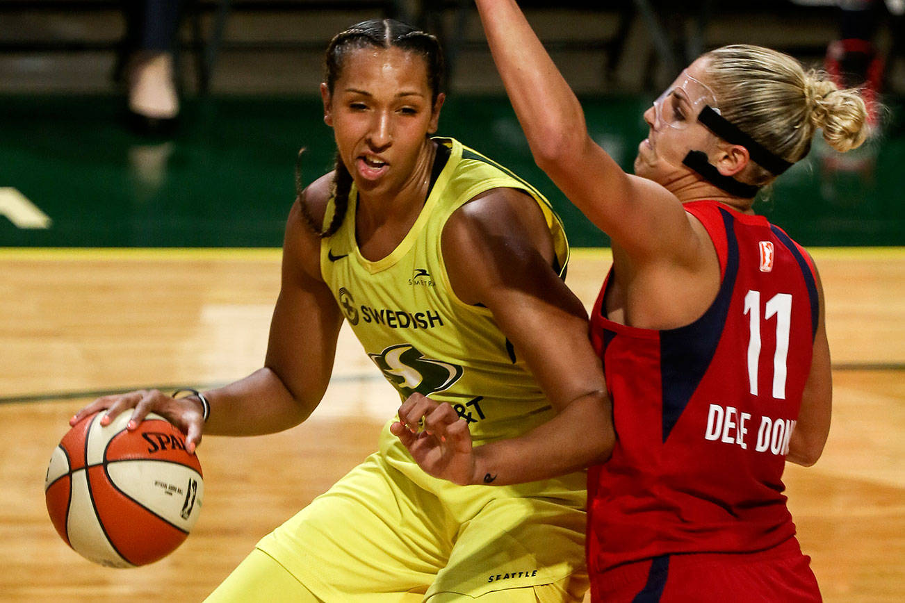 Seattle’s Mercedes Russell works the post with Washington’s Elena Delle Donne defending Friday evening at Angel of the Winds Arena in Everett in August 2, 2019. The Washington Mystics won 99-79. (Kevin Clark / The Herald)