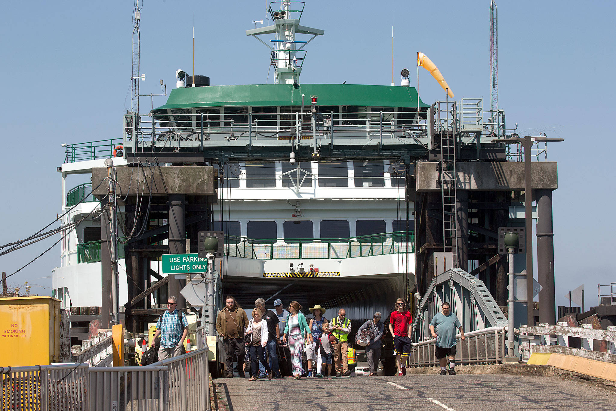 Walk-on passengers disembark from the ferry Suquamish at the Mukilteo ferry dock on Tuesday, Aug. 6, 2019 in Mukilteo, Wa. The Washington State Transportation Commissioners on Tuesday approved all of the proposed ferry rate increases for passengers and cars. (Andy Bronson / The Herald )