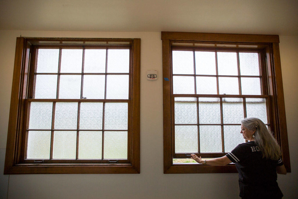 Debbie Copple shows one of the restored windows in the event center. (Olivia Vanni / The Herald)
