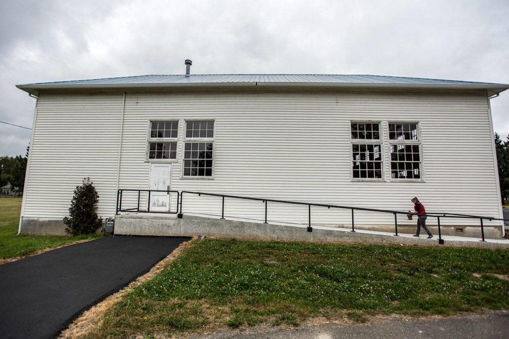 Mary Ritzman walks outside the Startup Event Center with a can of paint. (Olivia Vanni / The Herald)
