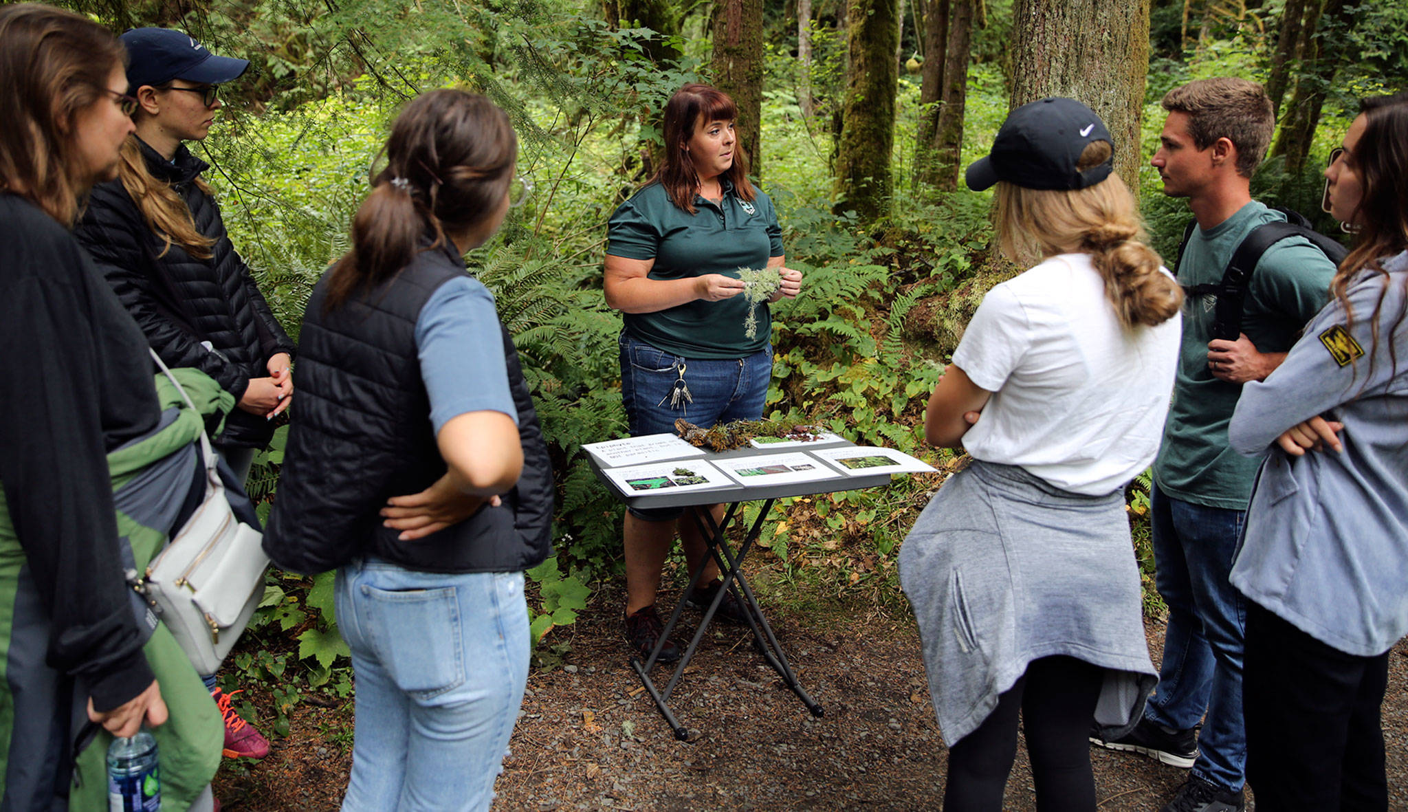 Leslie Holmes (center) gives a brief talk on the native plants at Wallace Falls State Park in Gold Bar. (Kevin Clark / The Herald)