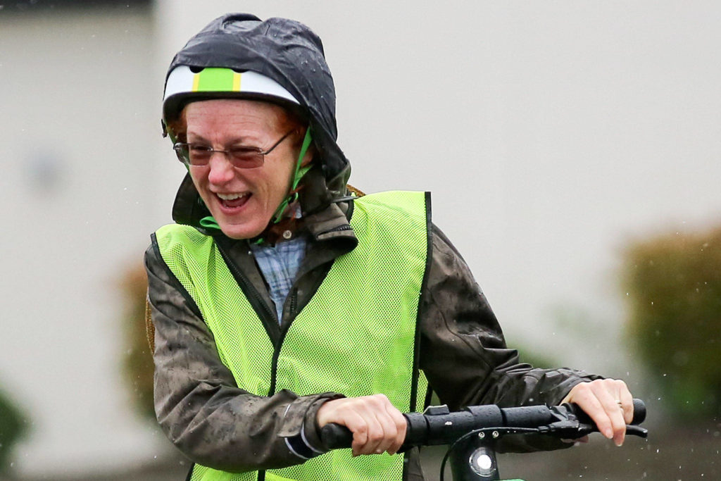 Sandra Dallas enjoys her ride on a e-scooter Saturday morning in Everett on August 10, 2019. (Kevin Clark / The Herald)
