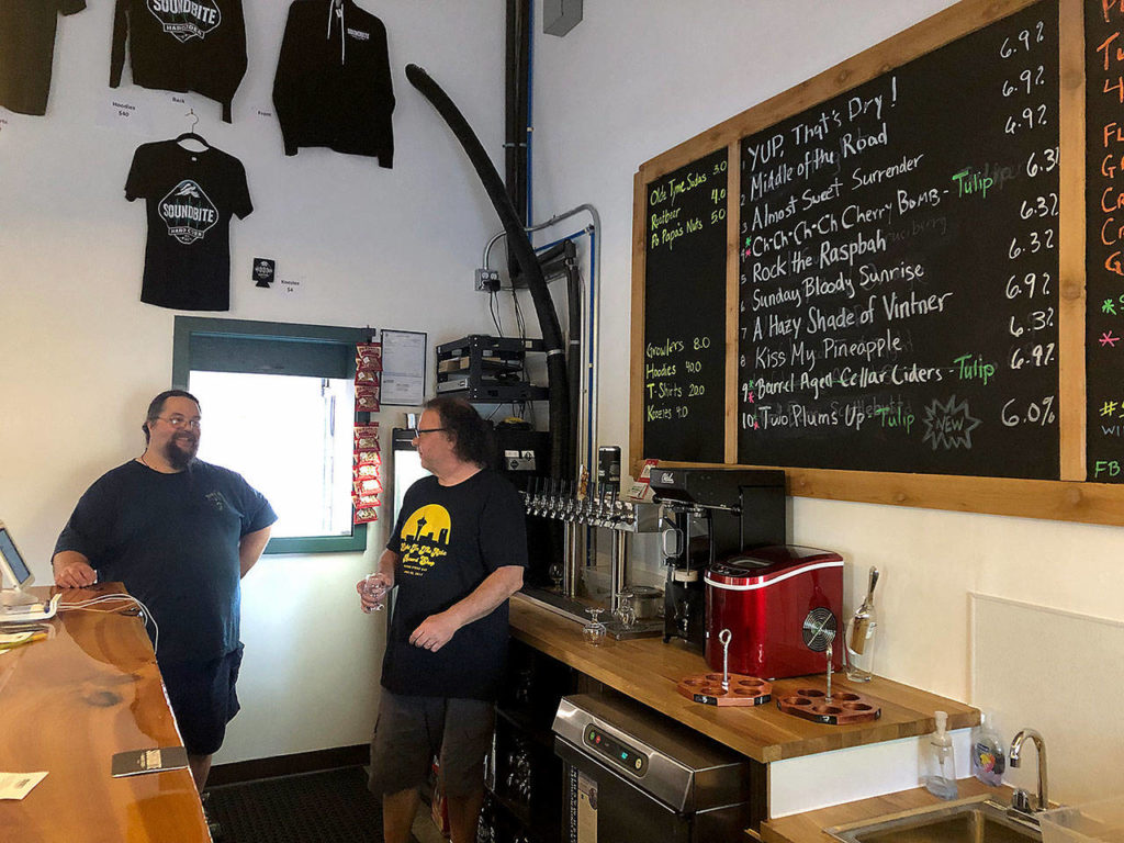 Soundbite Cider owner Robert Fontaine (right) and his right-hand man, John Fleming, chat in the cidery’s taproom recently. (Aaron Swaney)
