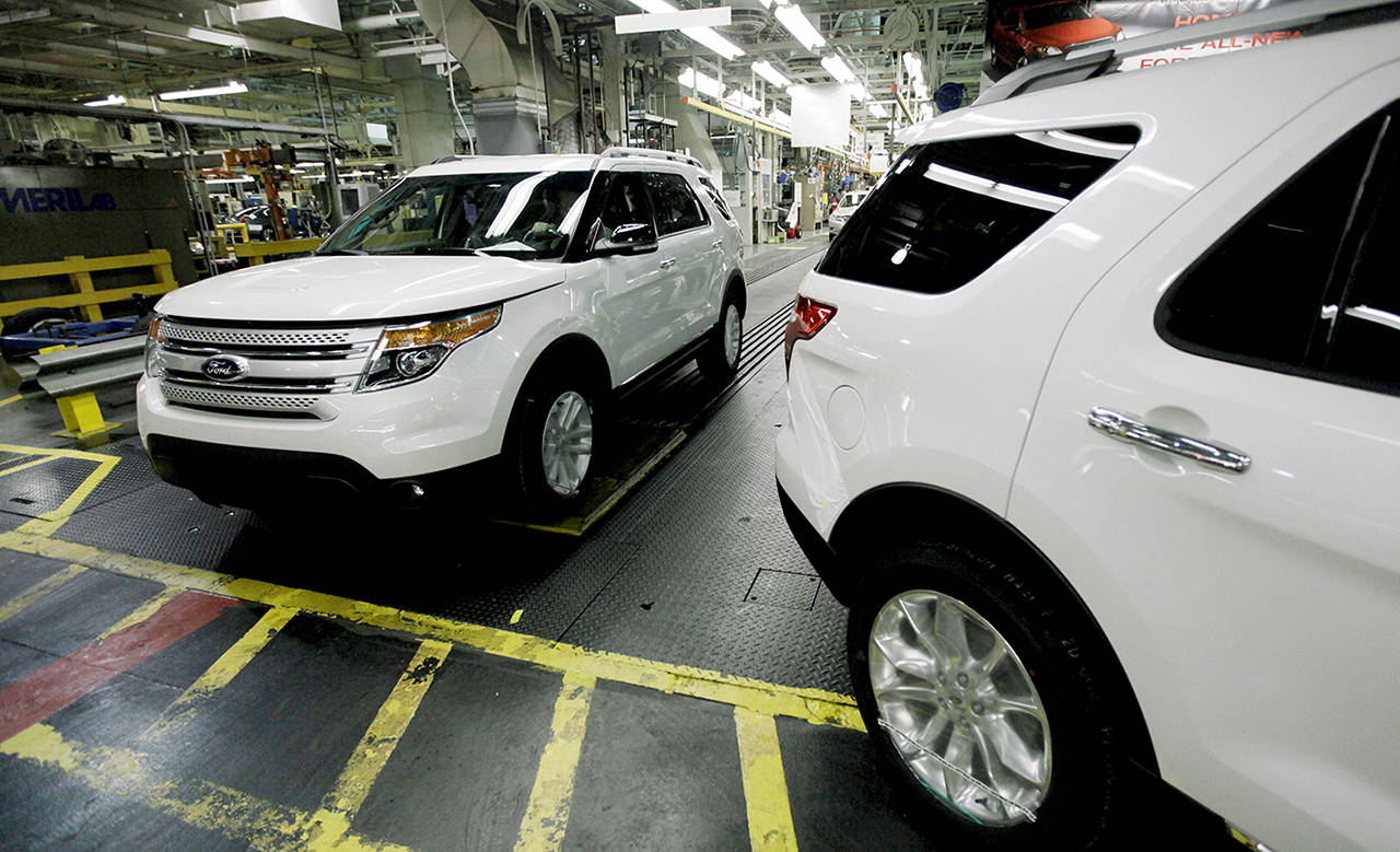 In this 2010 photo, plant employees drive 2011 Ford Explorer vehicles off the assembly line at Ford’s Chicago Assembly Plant in Chicago. The U.S. government is investigating complaints from Ford Explorer owners who say they smelled exhaust gas inside their SUVs. (AP Photo/M. Spencer Green, File)