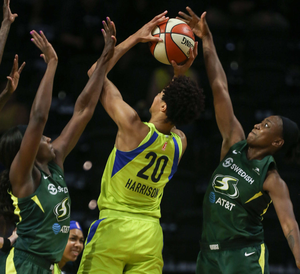 Dallas’ Isabelle Harrison (center) has her shot blocked by Seattle’s Jewell Loyd (right) with Seattle’s Crystal Langhorne (left) defending during a game on Aug. 8, 2019, at Angel of the Winds Arena in Everett. (Kevin Clark / The Herald)
