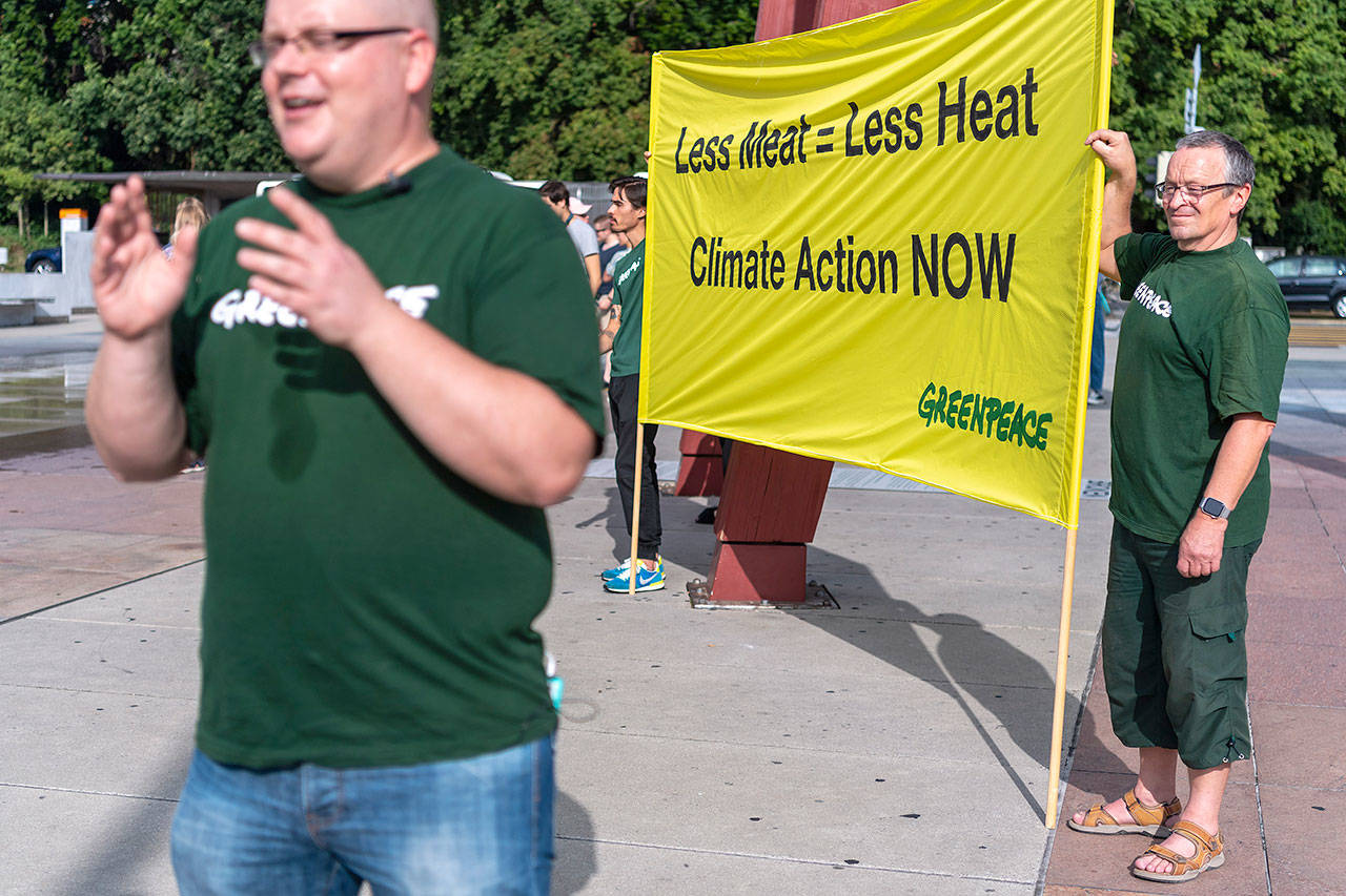 Greenpeace activists hold a banner in front of the United Nations before a news conference on the Special Report on Climate Change and Land after IPCC’s 50th session in Geneva, Switzerland, on Thursday. (Martial Trezzini/Keystone via AP)