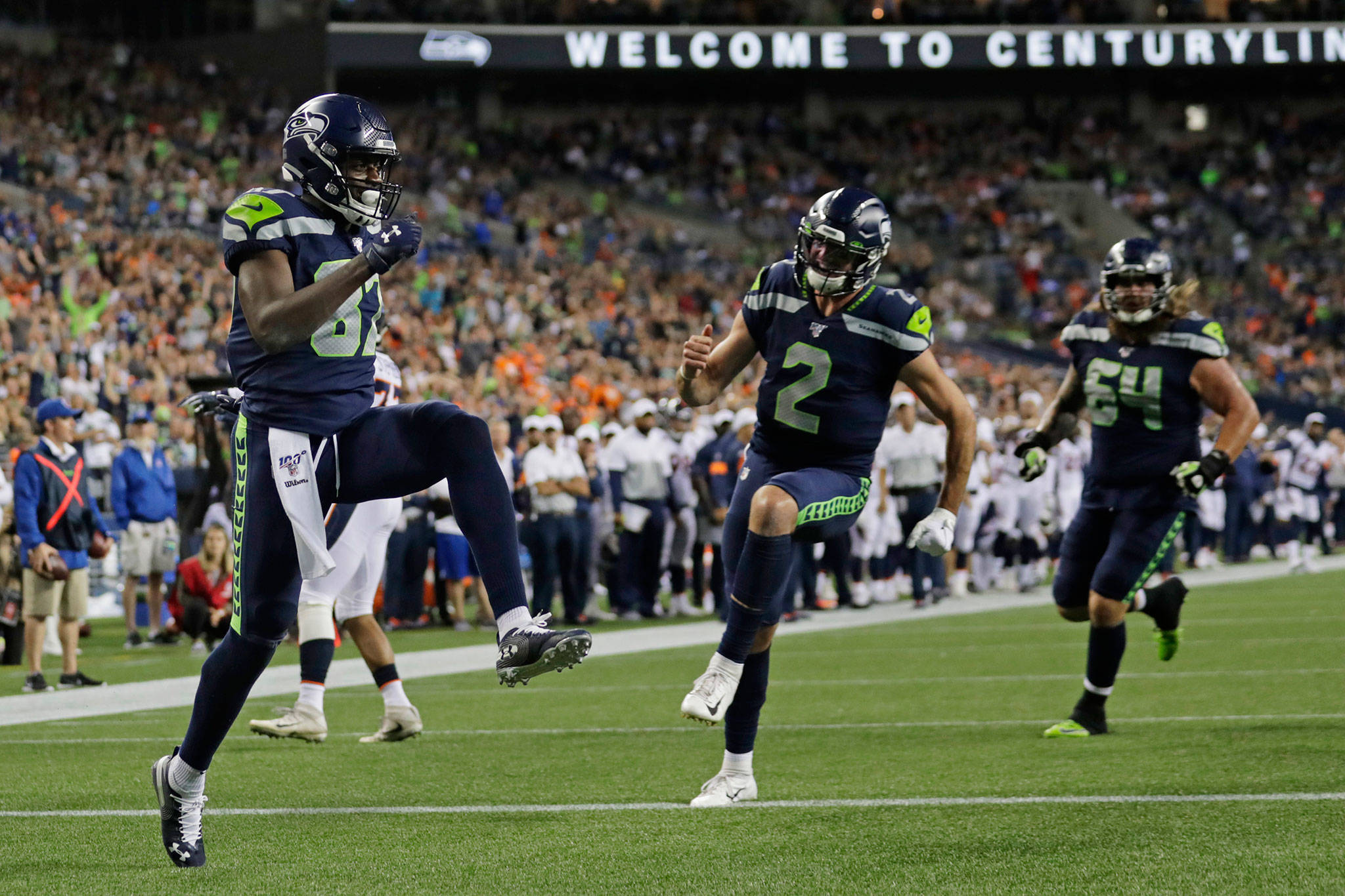 Seahawks wide receiver Jazz Ferguson (left) celebrates after catching a touchdown pass from quarterback Paxton Lynch (2) during a preseason game against the Broncos on Aug. 8, 2019, in Seattle. (AP Photo/Stephen Brashear)