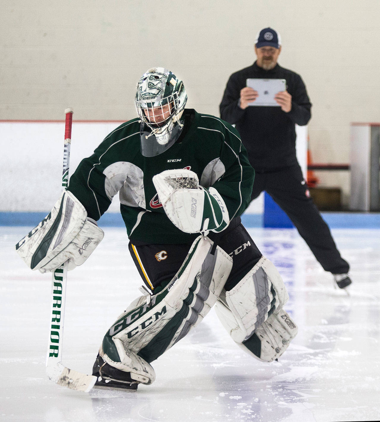 Silvertips goaltender Dustin Wolf skates backward as he trains with his goalie coach, James Jensen, at the Lynnwood Ice Center on July 18, 2019 in Lynnwood. (Andy Bronson / The Herald)
