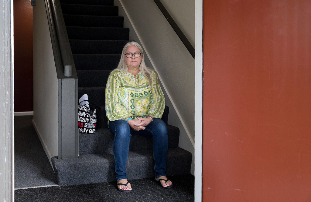 Beverly Bowers sits in the stairwell of her new place. The longtime Baker Heights resident had been dreading the move from the aging housing complex. (Lizz Giordano / The Herald)

