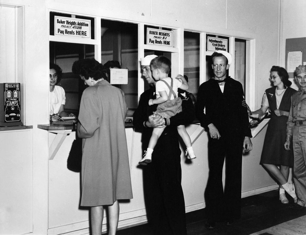In an undated photo, Baker Heights residents pay rent. (Everett Public Library)
