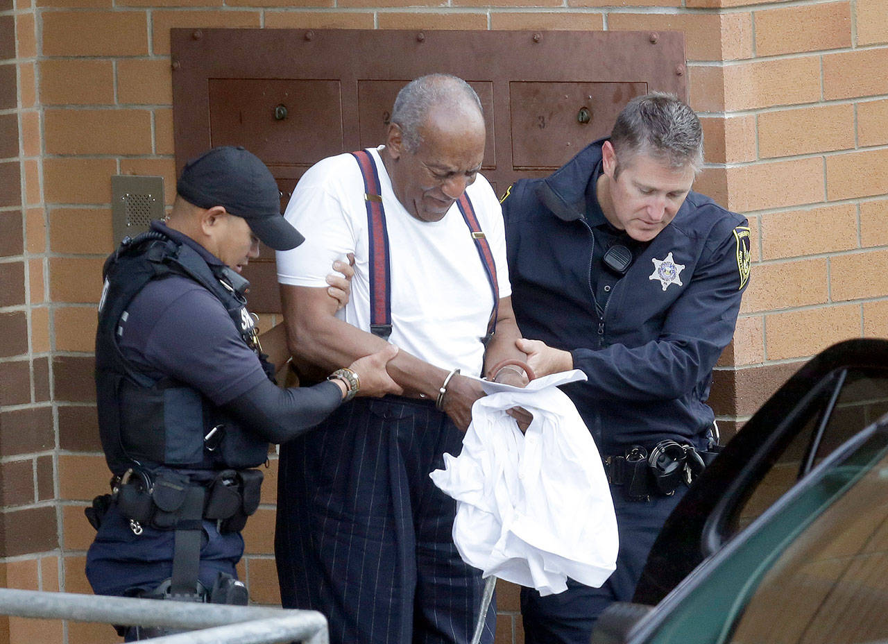 Bill Cosby is escorted out of the Montgomery County Correctional Facility, in Eagleville, Pennsylvania, in 2018 following his sentencing for sexual assault. (AP Photo/Jacqueline Larma, File)