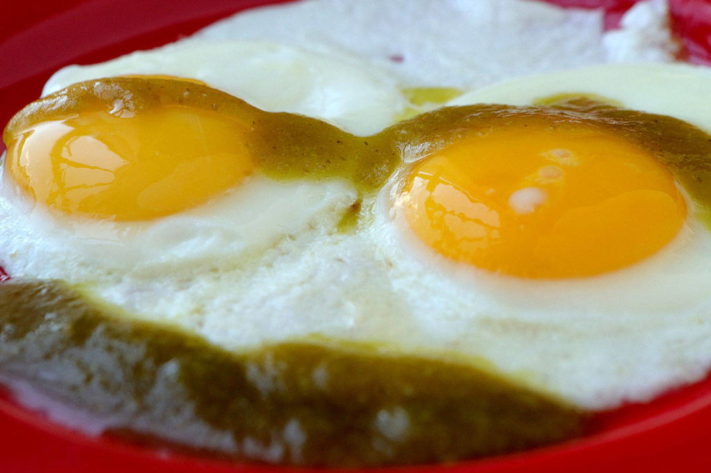 Green hot sauce dresses up sunny-side-up eggs. (Hillary Levin/St. Louis Post-Dispatch/TNS)
