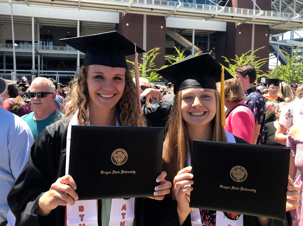 Mikayla Pivec celebrates her graduation from Oregon State University in June along with OSU basketball teammate Katie McWilliams. (Photo by Ron Callan)
