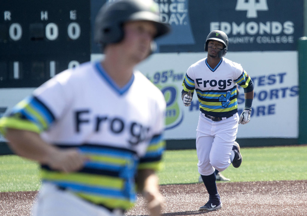 AquaSox’s Robert Perez follows Trent Tingelstad to home plate after hitting a three run homer as the The Everett AquaSox took on the Hillsboro Hops at Funko Field on Tuesday, Aug. 13, 2019 in Everett, Wash. (Andy Bronson / The Herald)
