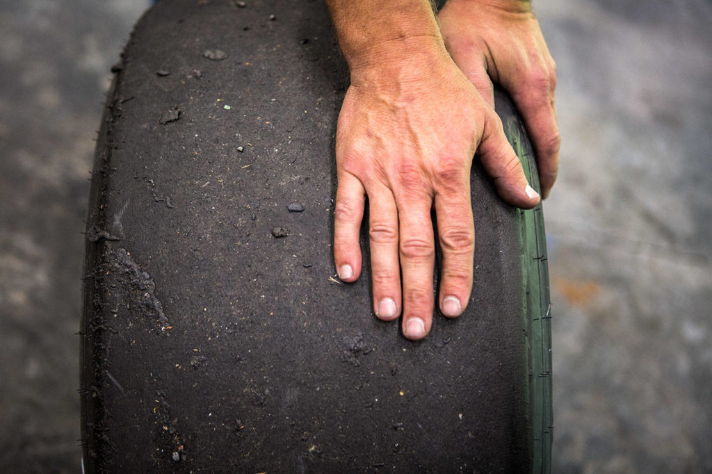 Crew chief Tom Hughs explains tire temperature and what kind of wear they look for on the front tires on Aug. 13, 2019 in Woodinville. (Olivia Vanni / The Herald)
