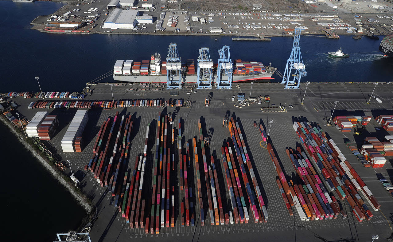 In this March 5 photo, cargo containers are staged near cranes at the Port of Tacoma. Most economists were already worried that the odds of a recession are rising, and most of the worries stem from the U.S.-China trade war. (AP Photo/Ted S. Warren file)