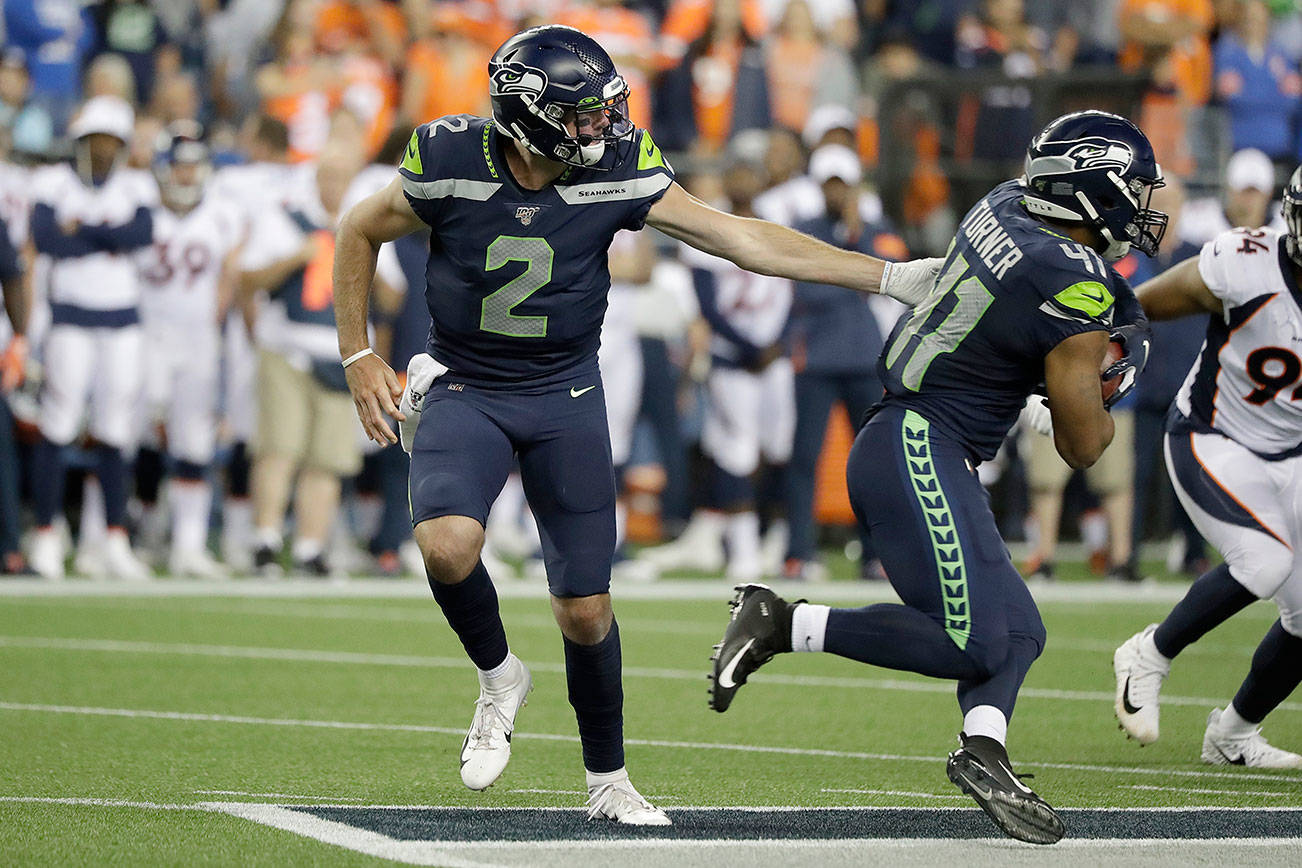 Seattle Seahawks quarterback Paxton Lynch (2), handing off to running back Xavier Turner during the second half of last Thursday’s preseason game against the Denver Broncos, was the voters’ runaway choice to back up Russell Wilson this season. (AP Photo/Elaine Thompson)