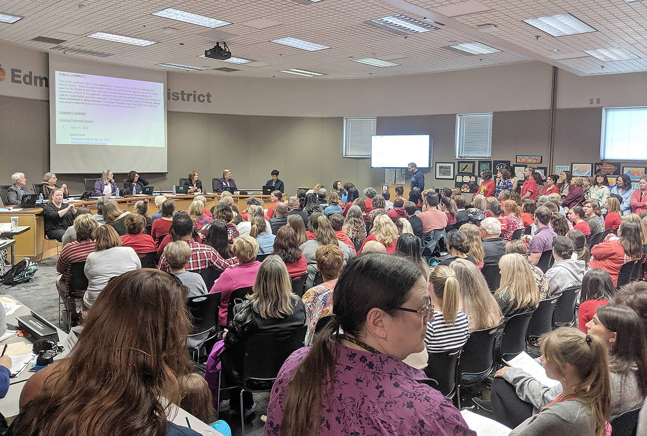 Fewer teachers received pink slips than was feared by students, teachers and parents after this emotion-packed Edmonds School Board meeting last May. (Zachariah Bryan / Herald file)