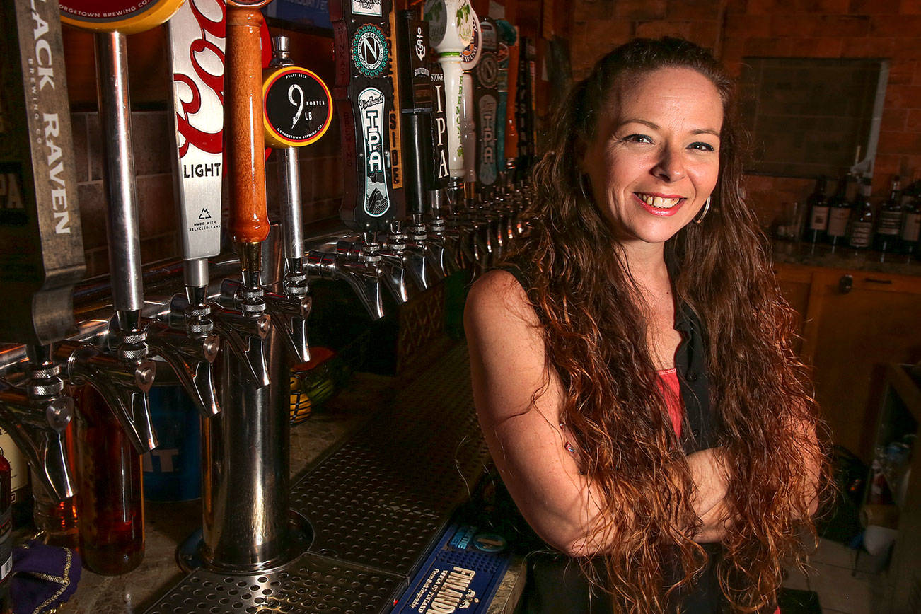 Megan Bingaman tends bar for Village Taphouse & Grill in Marysville. (Kevin Clark / The Herald)