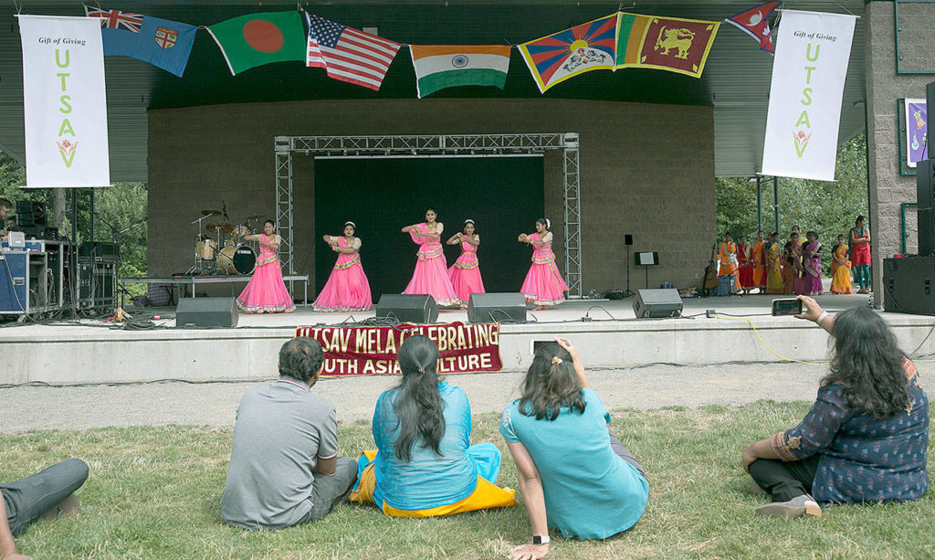 Festival goers watching dance students perform at the second annual UTSAV Mela. It’s a festival that celebrates South Asian cultures and aims to share traditional dances, food and fashion with area locals. (Julia-Grace Sanders / The Herald)
