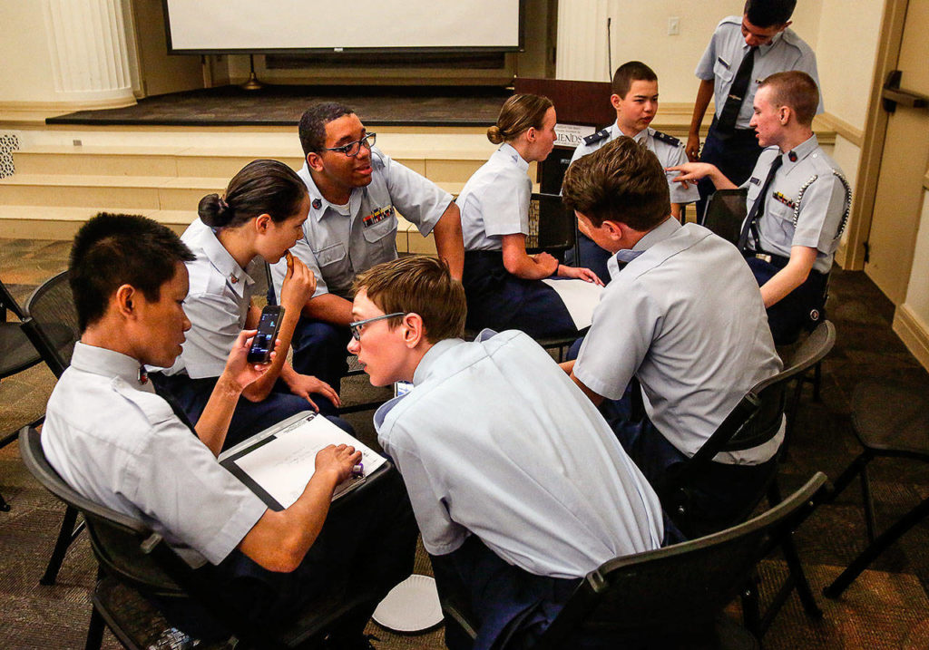 Teens who are part of the Civil Air Patrol’s Overlake Composite Squadron interviewed and made videos of veterans at the Everett Public Library Monday. (Dan Bates / The Herald)
