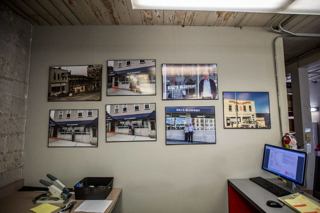 Family photos hang on the wall at Bill’s Blueprints in Everett. (Olivia Vanni / The Herald)
