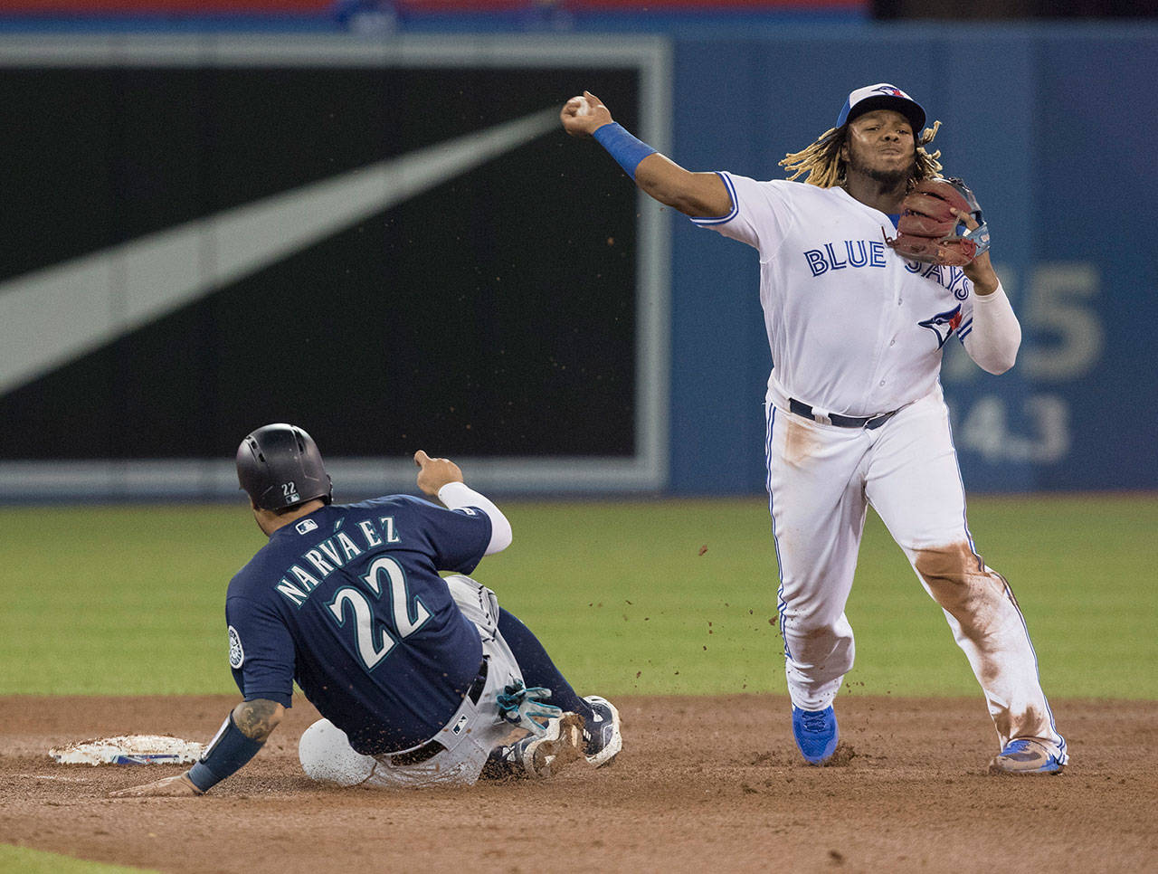 The Blue Jays’ Vladimir Guerrero Jr. throws to first after forcing out the Mariners’ Omar Navarez during the sixth inning of a game on Aug. 16, 2019, in Toronto. (Fred Thornhill/The Canadian Press via AP)