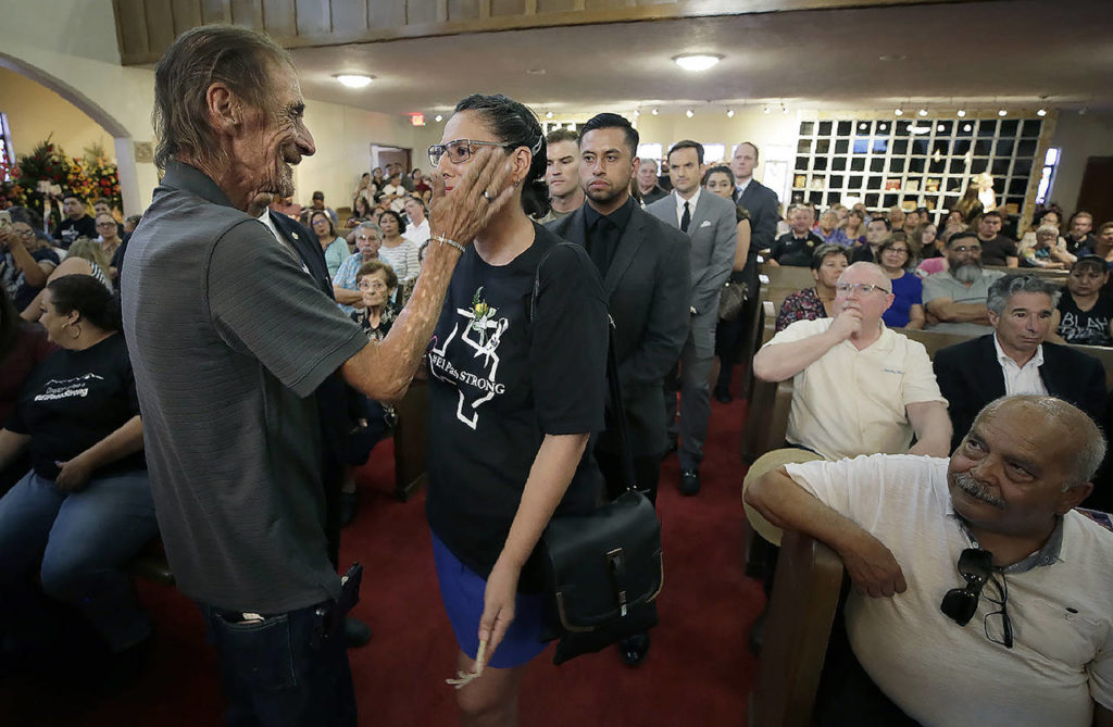 Antonio Basco wipes a tear from the eye of Patricia Vargas at the funeral of his companion of 22 years, Margie Reckard, at La Paz Faith Memorial & Spiritual Center, on Friday. (Mark Lambie/The El Paso Times via AP)
