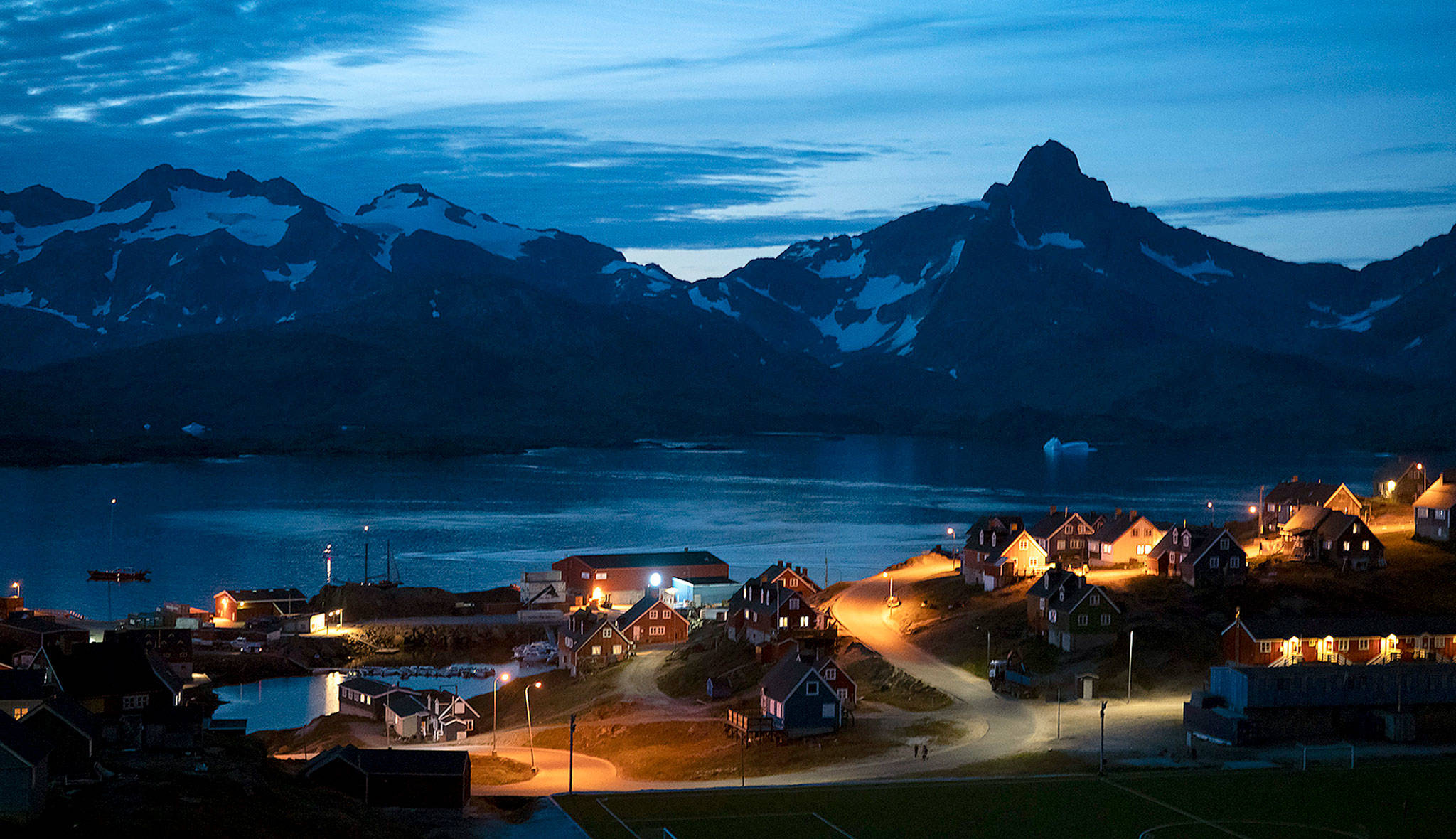 Homes are illuminated after the sunset in Tasiilaq, Greenland. (AP Photo/Felipe Dana)