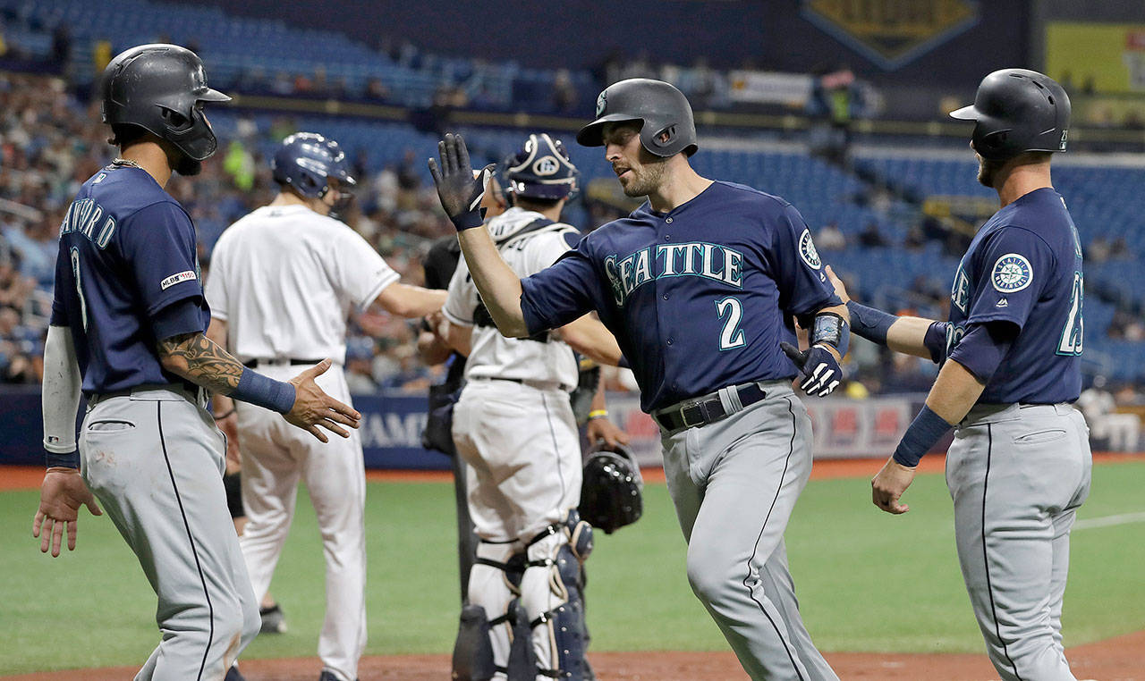 Seattle’s Tom Murphy (2) celebrates with J.P. Crawford (3) and Austin Nola (23) after Murphy hit a three-run home run off Tampa Bay’s Brendan McKay during the first inning the Mariners’ 9-3 win Monday in St. Petersburg, Florida. (AP Photo/Chris O’Meara)