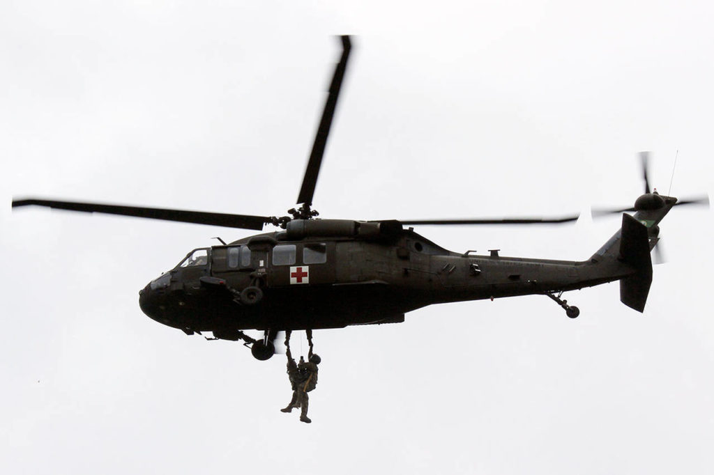 Members of the Washington National Guard show young people a helicopter rescue demonstration on Wednesday at Camp Killoqua in Stanwood. (Stephanie Dvaey / The Herald)
