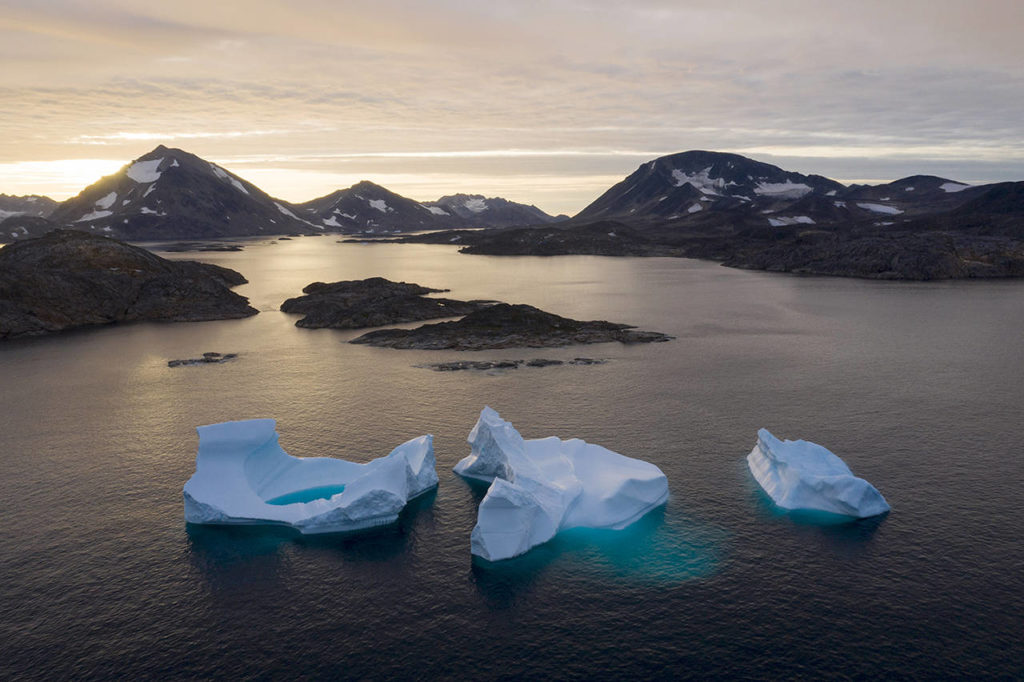 In this Aug. 16 photo, large Icebergs float away as the sun rises near Kulusuk, Greenland. (AP Photo/Felipe Dana)
