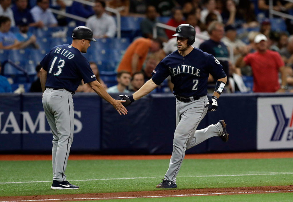 Seattle’s Tom Murphy (2) shakes hands with third-base coach Chris Prieto (13) after Murphy hit a two-run home run off Tampa Bay Rays relief pitcher Jalen Beeks in the sixth inning of Tuesday’s game in St. Petersburg, Florida. (AP Photo/Chris O’Meara)
